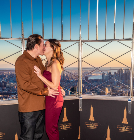 Couple kissing on top of the Empire State Building