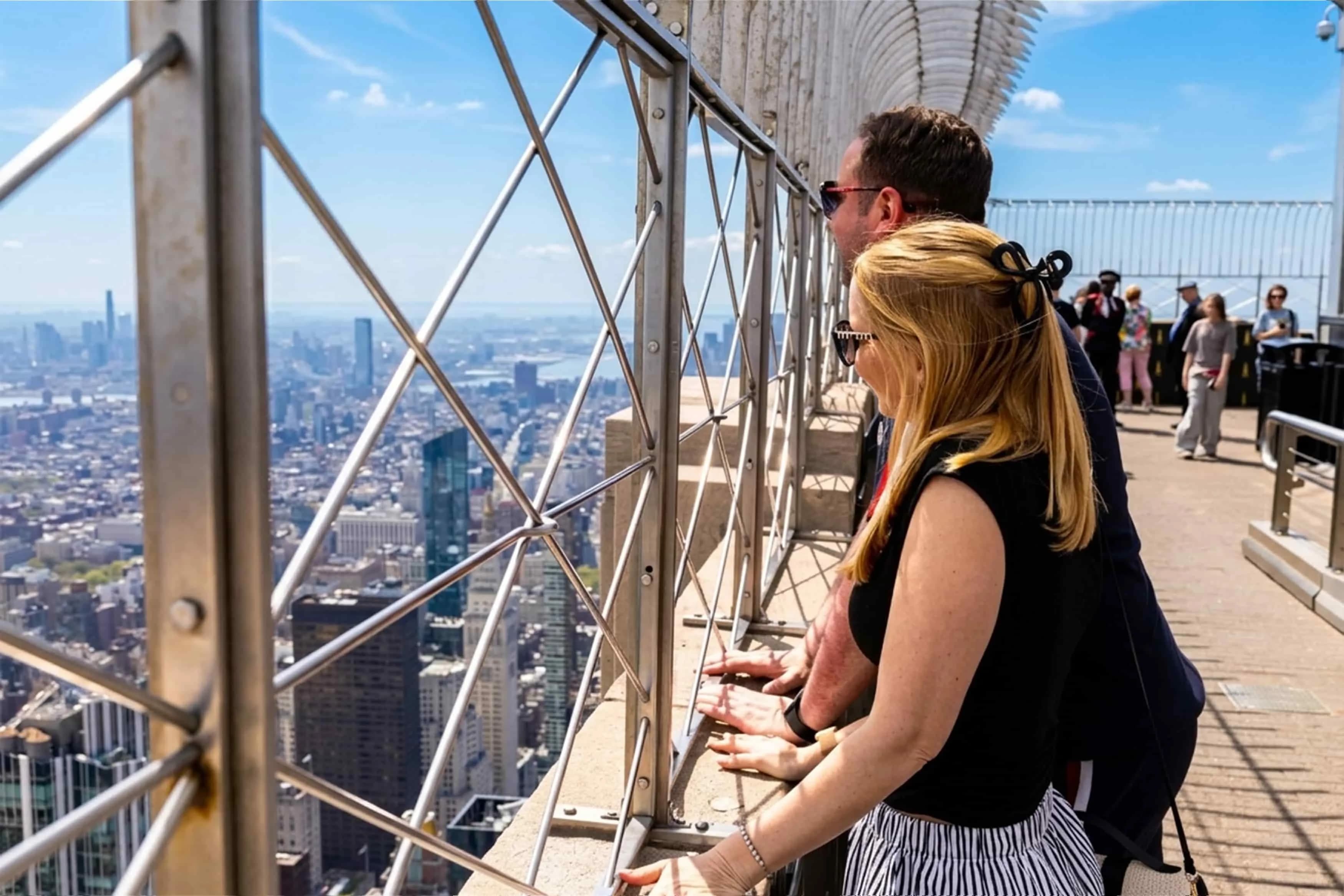 People looking out at the Empire State Building's 86th Floor Observation Deck