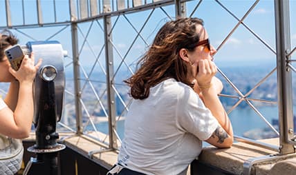Woman looking out the Empire State Building's 86th Floor Observatory