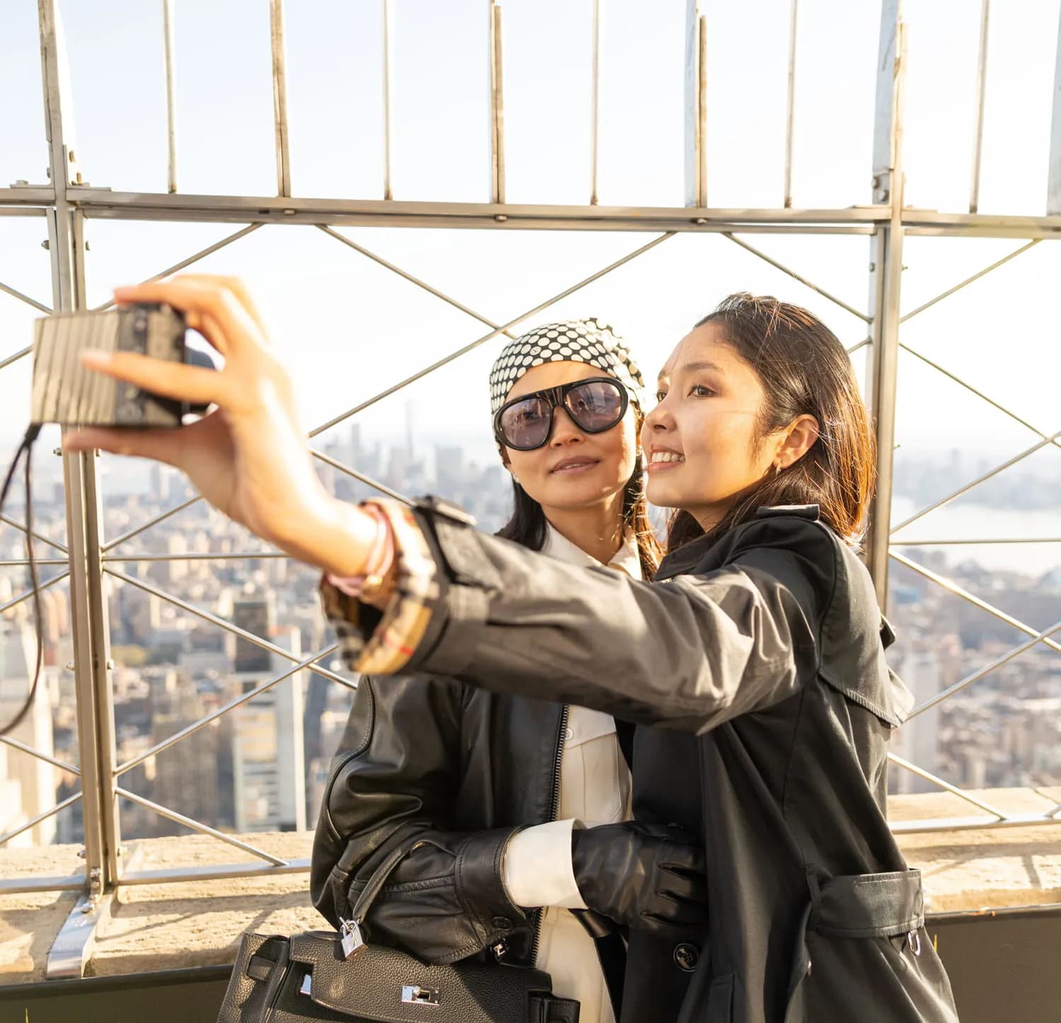 Two women taking selfies in front of the best views of Manhattan