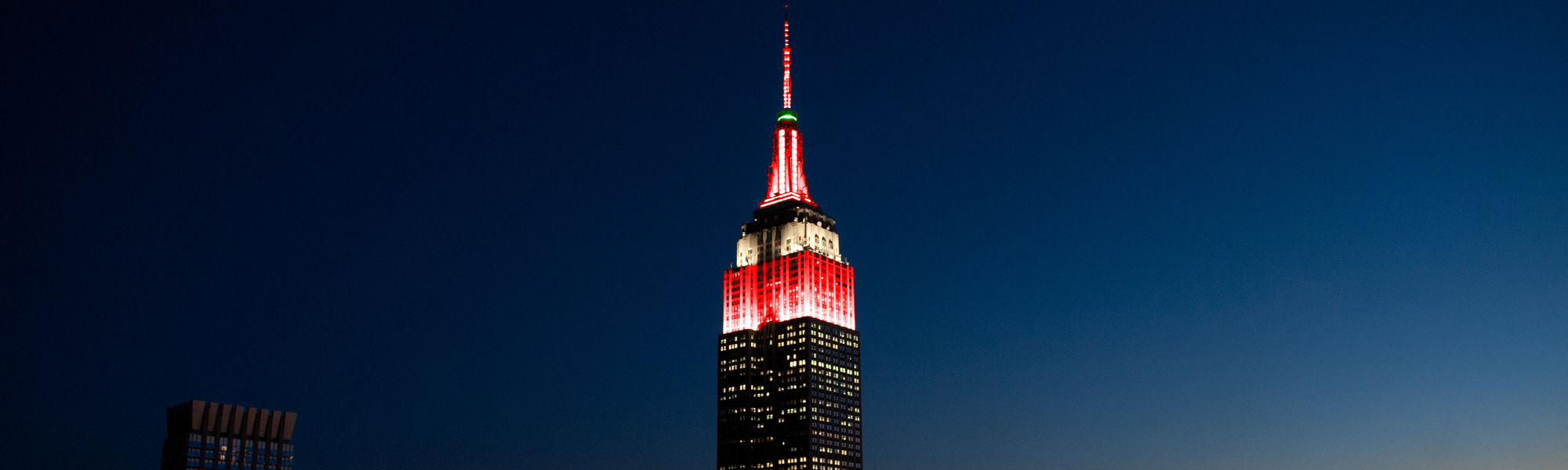 The Empire State Building in red, white, and green.