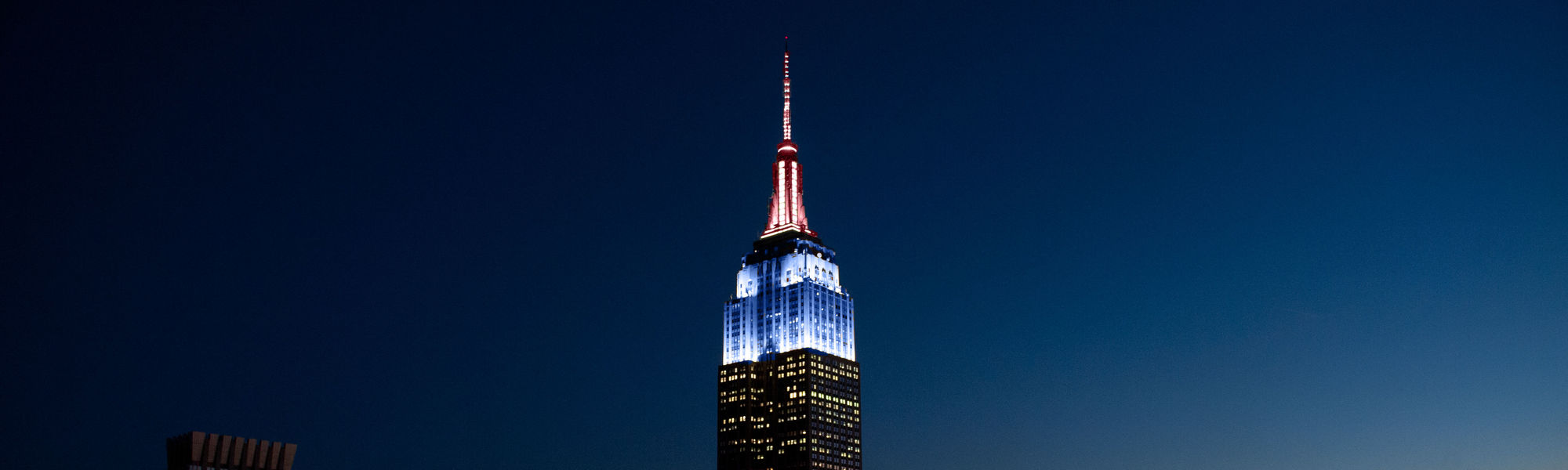 The Empire State Building lit in rose quartz and serenity