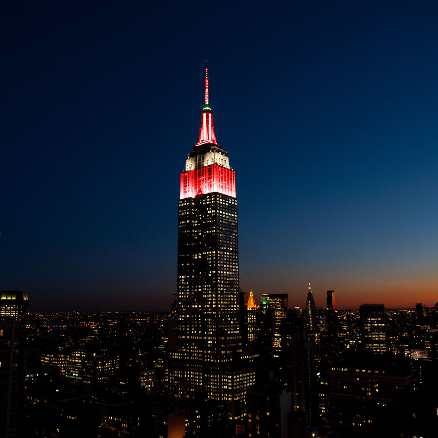 The Empire State Building in red, white, and green.