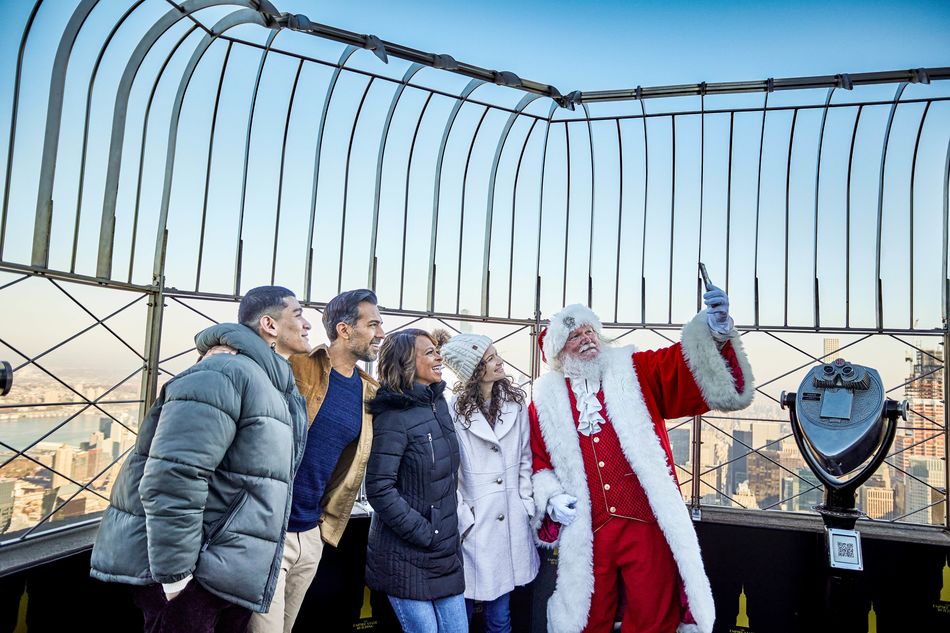 Santa poses for a photo with a family