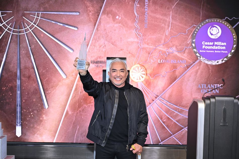 Cesar Millan holds his ESB model at the lighting ceremony