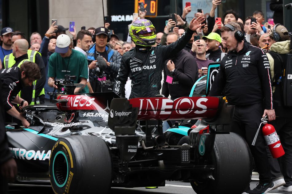 Lewis Hamilton waves to fans after historic stunt