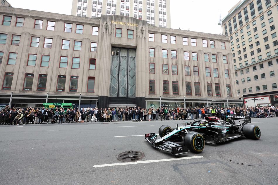 Lewis Hamilton drives a Mercedes F1 car in front of ESB