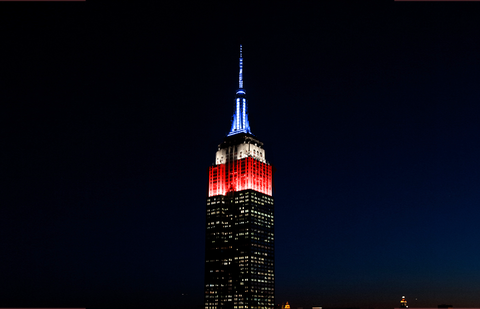 The Empire State Building lit in red, white, and blue