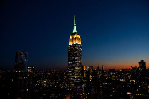 The Empire State Building lit in orange and green