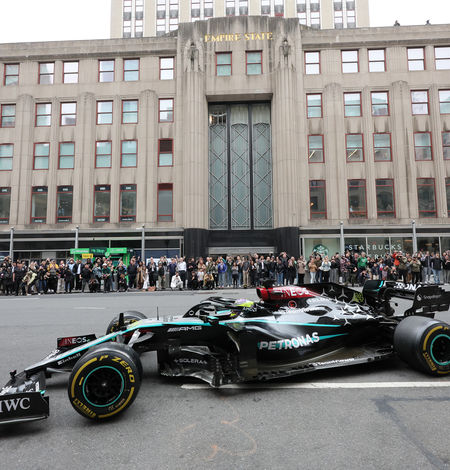 Lewis Hamilton drives a Mercedes-AMG F1 car in front of ESB